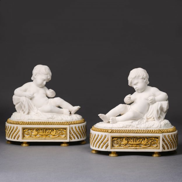 A Fine Pair of White Marble Sculptures of Reclining Putti