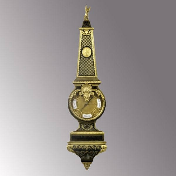 Baromètre de style Louis XIV en marqueterie Boulle montée en bronze doré.