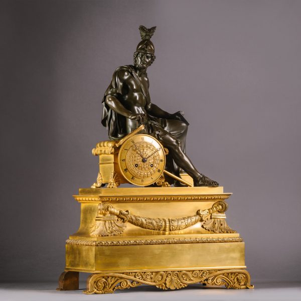 A Charles X Gilt and Patinated Bronze Figural Mantle Clock