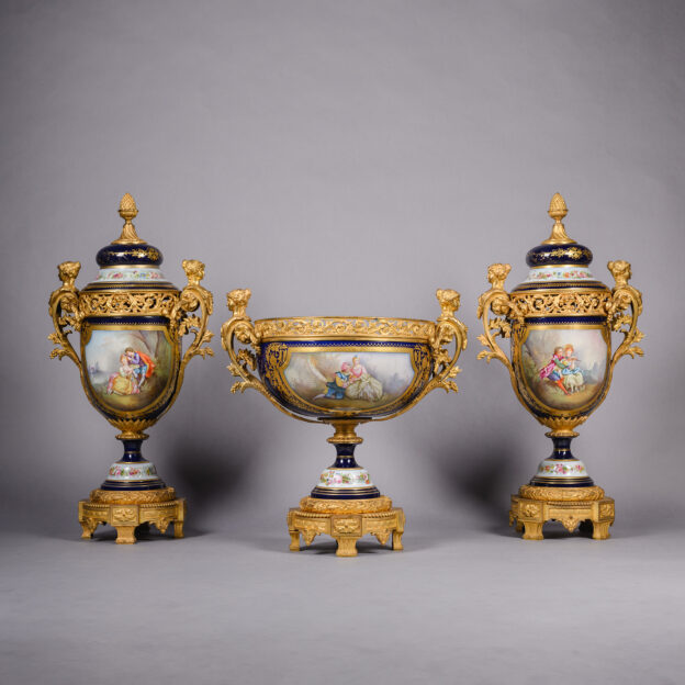 Napoléon III gilt-bronze mounted Sèvres style garniture set with centrepiece and pair of lidded vases, signed Robert, decorated with romantic scenes and floral bouquets, France circa 1870.