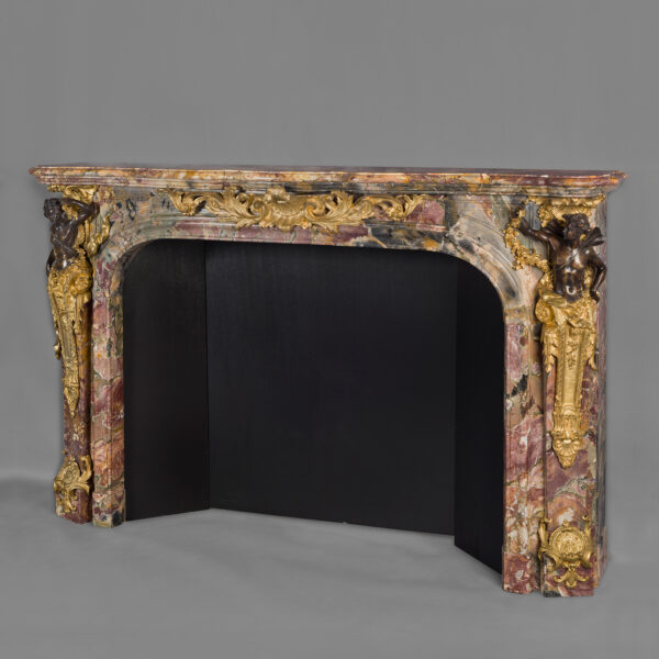 A Fine Louis XV Style Gilt and Patinated Bronze Mounted Marble Fireplace With Gilt Bronze Mounts Depicting Flora and Zephyr, After The Model by Verberckt and Caffieri at Versailles. French, Circa 1860.