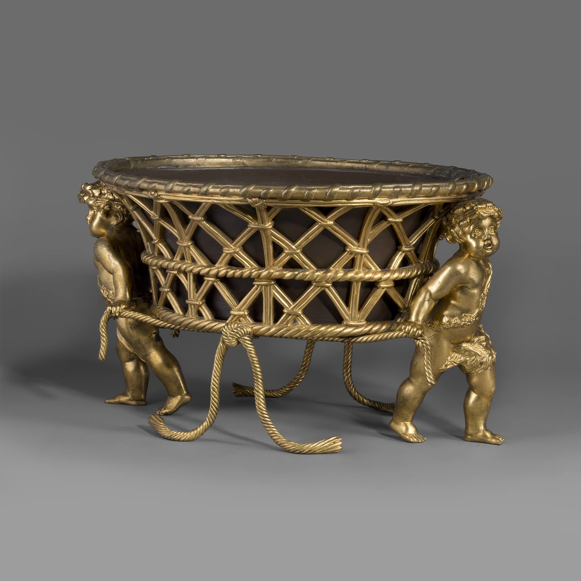 Louis XV style gilt-bronze jardiniere by Maison Alphonse Giroux, Paris, featuring an oval basket supported by two finely cast putti with original painted liner, circa 1860.