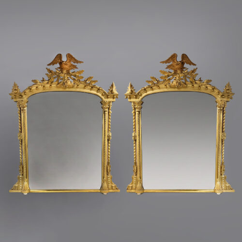 Pair of elaborately carved giltwood overmantel mirrors with eagle cresting