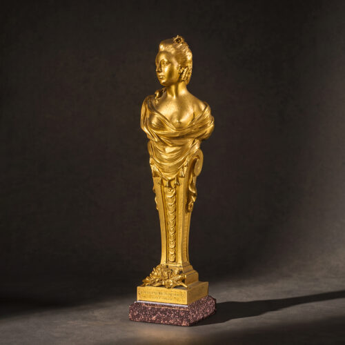 An 18th Century gilt-bronze term figure of Madame Pompadour on an Egyptian porphyry base