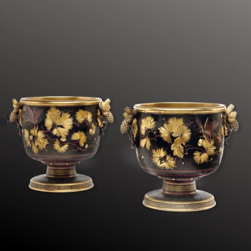 The large cache pots are finely cast in relief with leaves and insects. The handles are modelled as branches with pinecones. The circular socle and foot inlaid in gold Greek key pattern. Signed 'CHRISTOFLE & Cie' and numbered ‘1083602’ and ‘108360’. France, Circa 1880. These unusual cache pots are characteristic of Émile Reiber’s work at Christofle, where he was head of design from 1865. The decoration of pinecones and insects coupled with parcel gilding and brown patination is in the Japanese taste and inspired mixed-metal objects (mokume). They are part of a series of pieces in enamel cloisonne and incrusted bronze exhibited by Christofle at the Union Centrale des Beux-Arts in 1874, where Reiber was awarded a gold medal, and the Paris Expoisiton universelle in 1874. Compare a similar model of jardinière with pinecone handles and foliate decoration to the frieze, in the musée d’Orsay (inv. OAO 1017) and another in the MET (1991.88a, b).