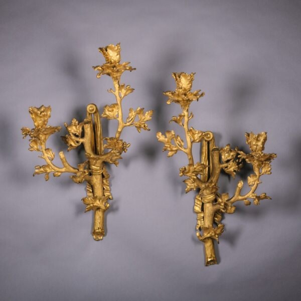 A Rare and Highly Unusual Pair of Gilt-Bronze Twin-Light Wall Appliques.