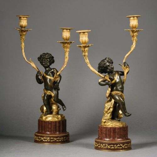A Pair of Louis XVI Style Gilt and Patinated Bronze Figural Candelabra. After The Model by Clodion. France, Circa 1880