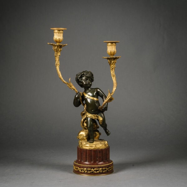 A Pair of Louis XVI Style Gilt and Patinated Bronze Figural Candelabra. After The Model by Clodion. France, Circa 1880