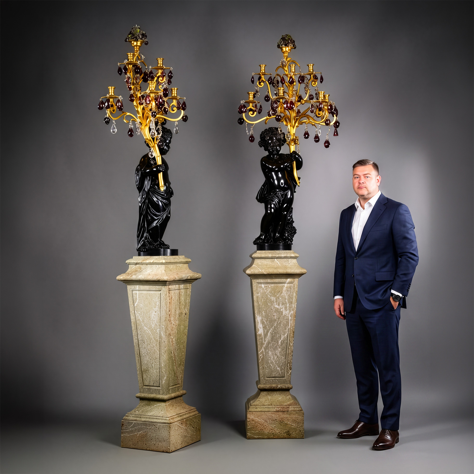 A Pair of Magnificent and Palatial Patinated Bronze Figural Putto Seven-Light Gilt-Bronze, Rock-Crystal and Amethyst Glass Candelabra