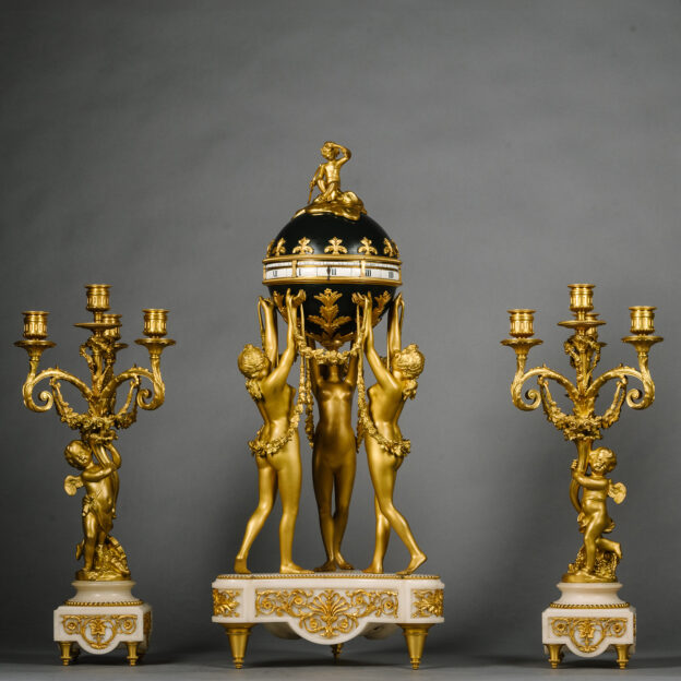 A Louis XVI Style Gilt and Patinated Bronze and Marble Clock Garniture
