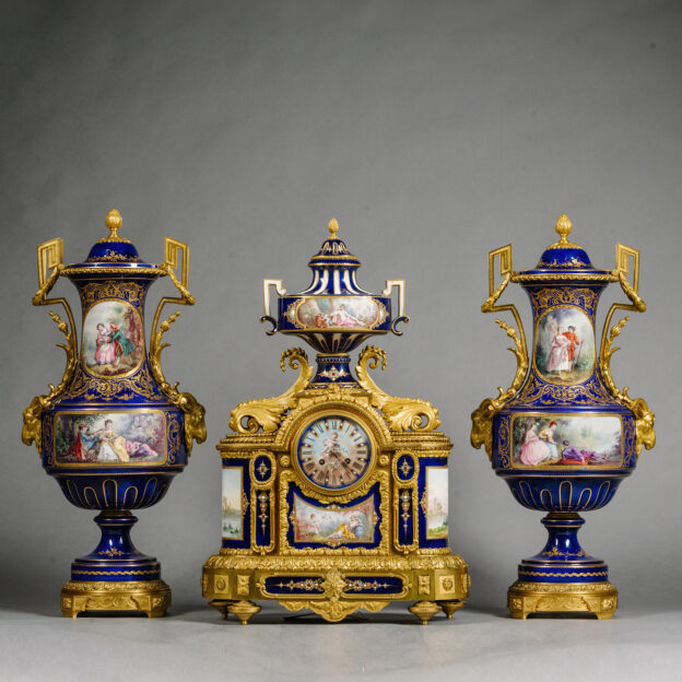 A Large Gilt-Bronze and Sèvres Style Cobalt Blue Ground Porcelain Three-Piece Clock Garniture.