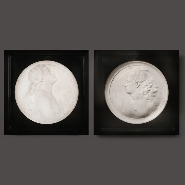 A Pair Of White Marble Portrait Roundels Of Female Portraits Representing 'Morning' and 'Evening', By Madison Colby