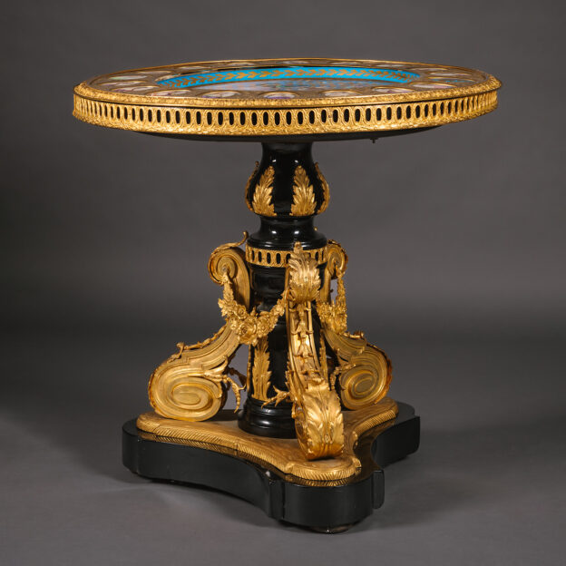 A Napoleon III Gilt-Bronze and Sèvres-Style Porcelain Mounted Ebonised Centre Table.