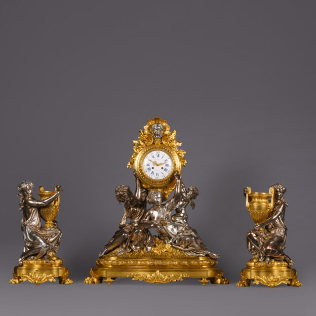 A Napoléon III Gilt and Silvered-Bronze Sculptural Three-Piece Clock Garniture, By Charpentier, Paris