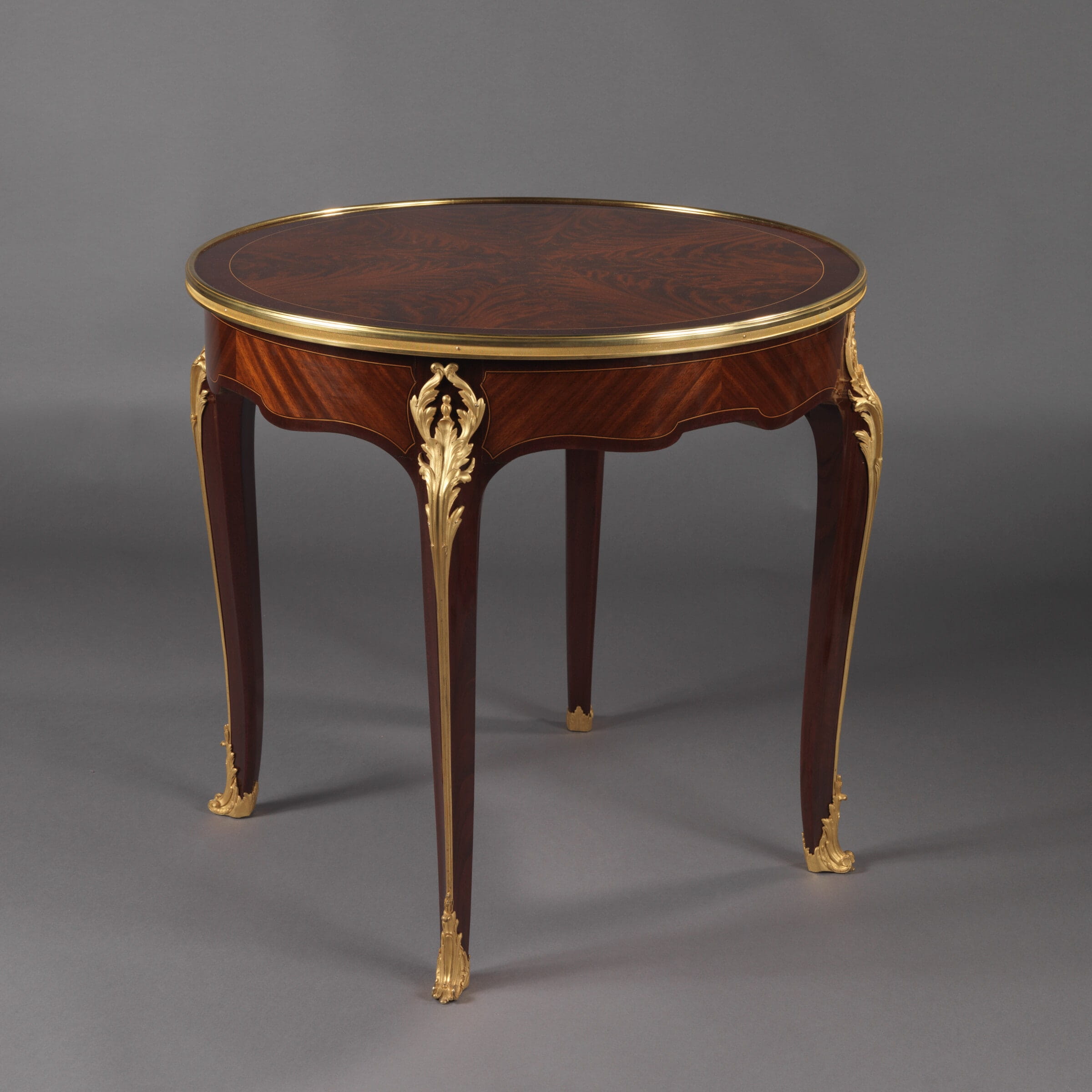 A Fine Mahogany Gueridon With A Reversible Baise Lined Top