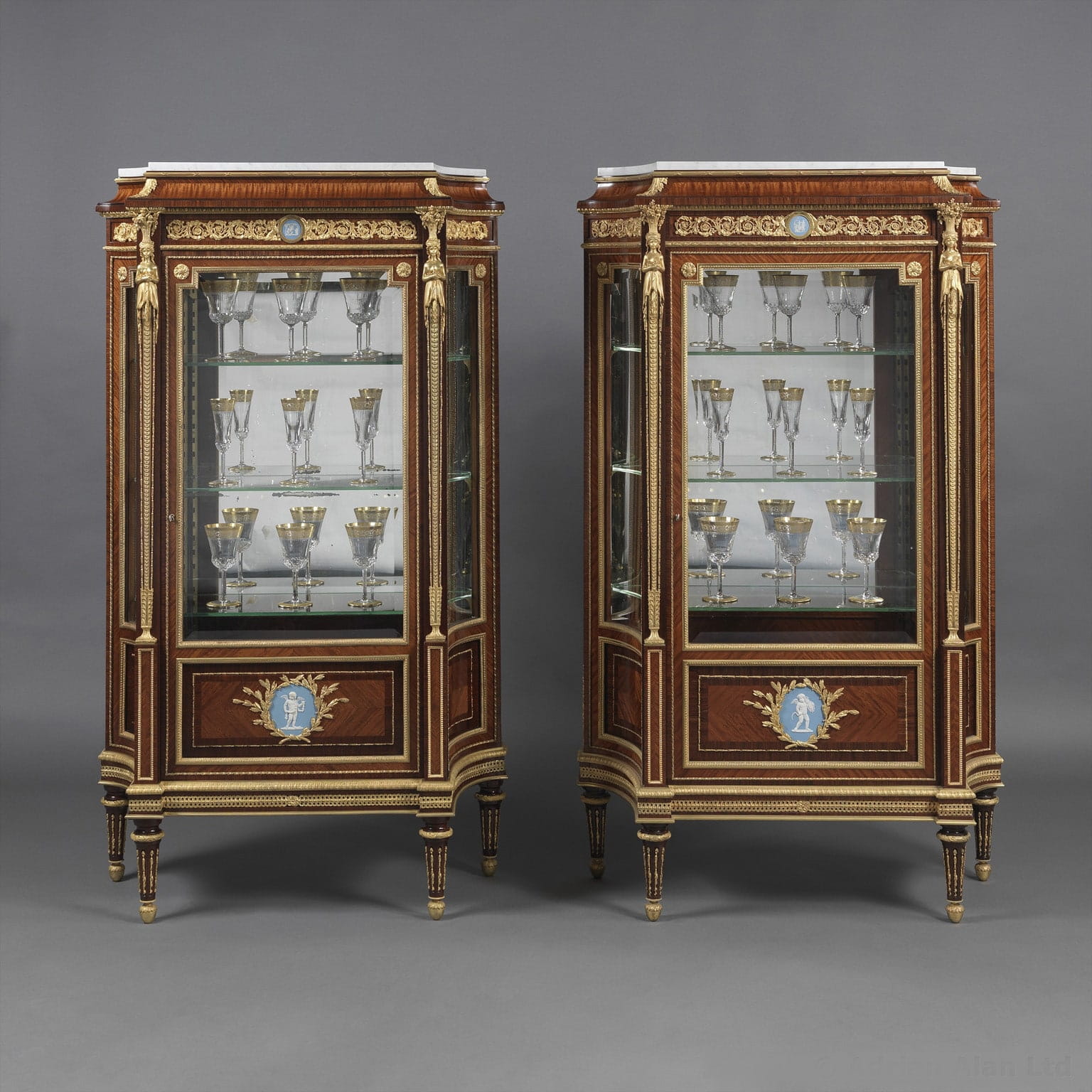 An Important Pair of Louis XVI Style Vitrines with Wedgwood Plaques