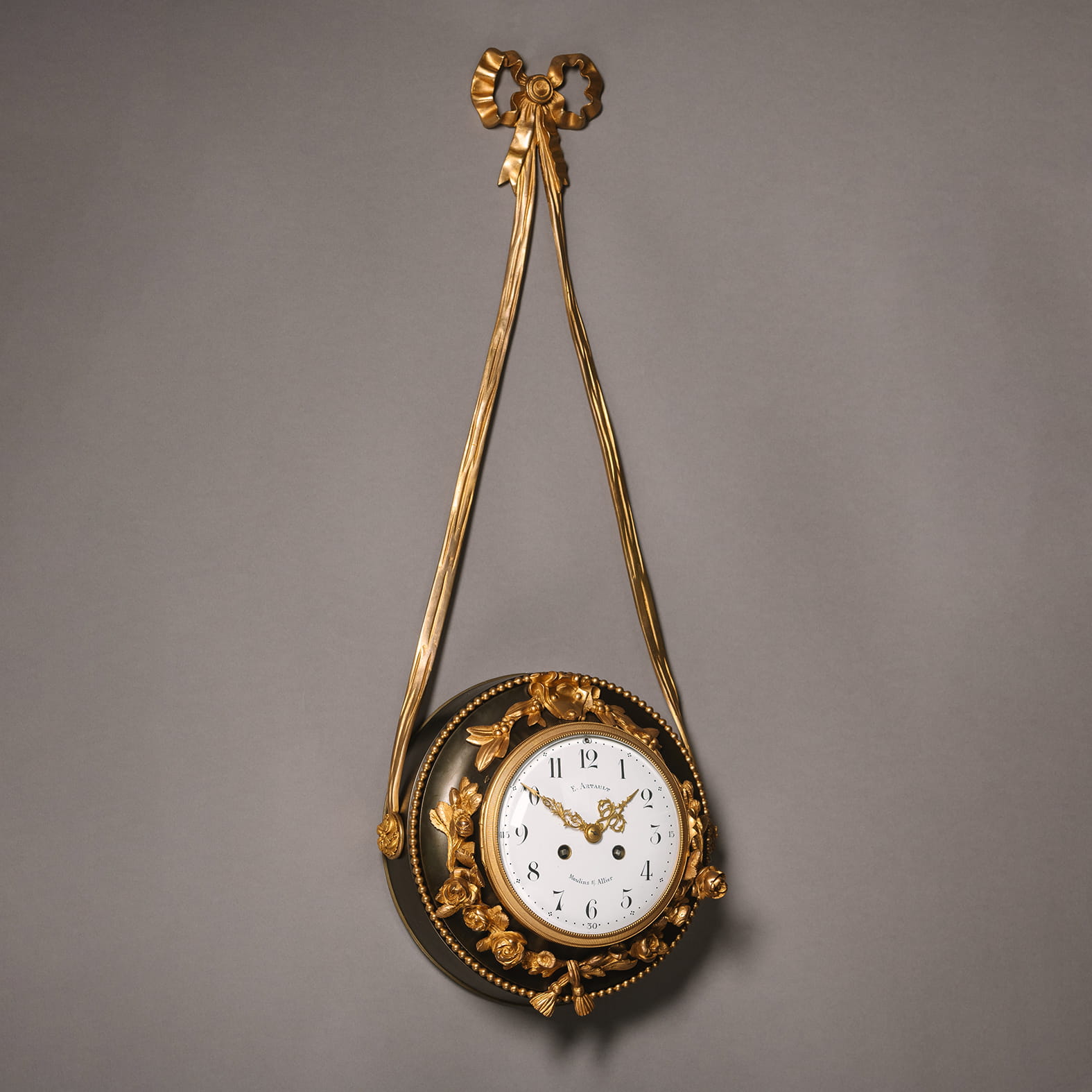 A Patinated and Gilt-Bronze Hanging Clock, with an enamelled dial and Arabic Numerals - Image 2
