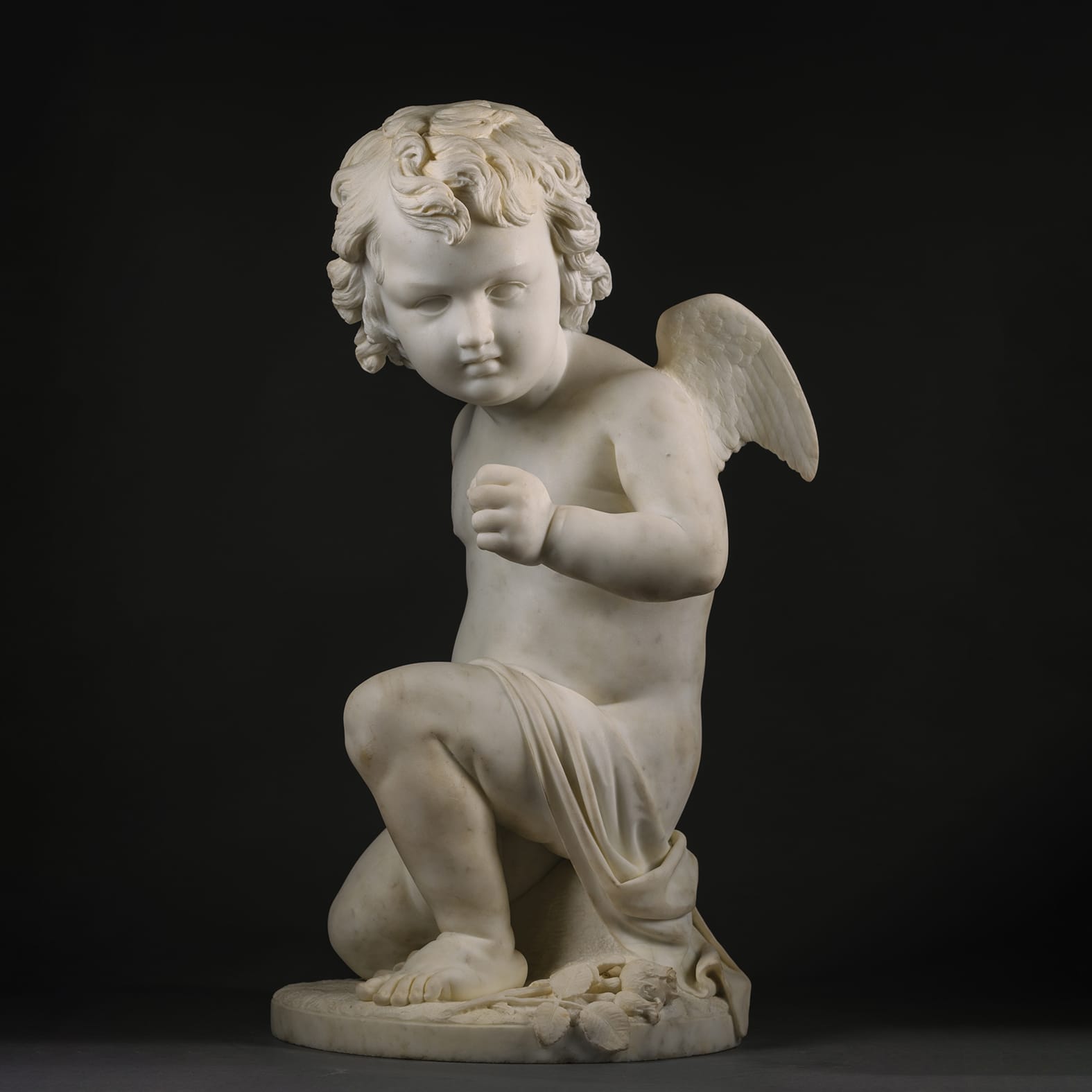 A Fine White Marble Figure of a Kneeling Cherub