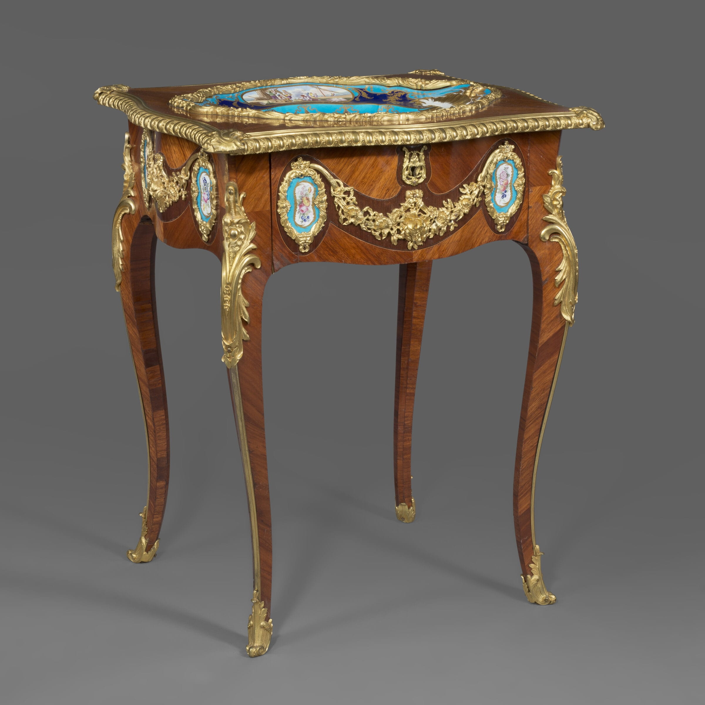 A Louis XV Style Gilt-Bronze Mounted and Porcelain Set Table