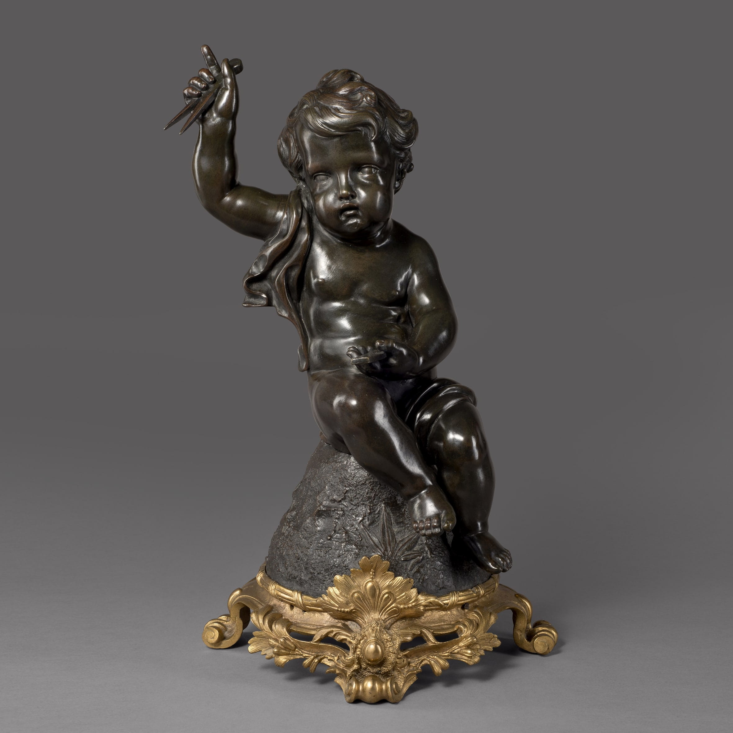 A Fine Patinated Bronze Putto Figure Emblematic of Architecture