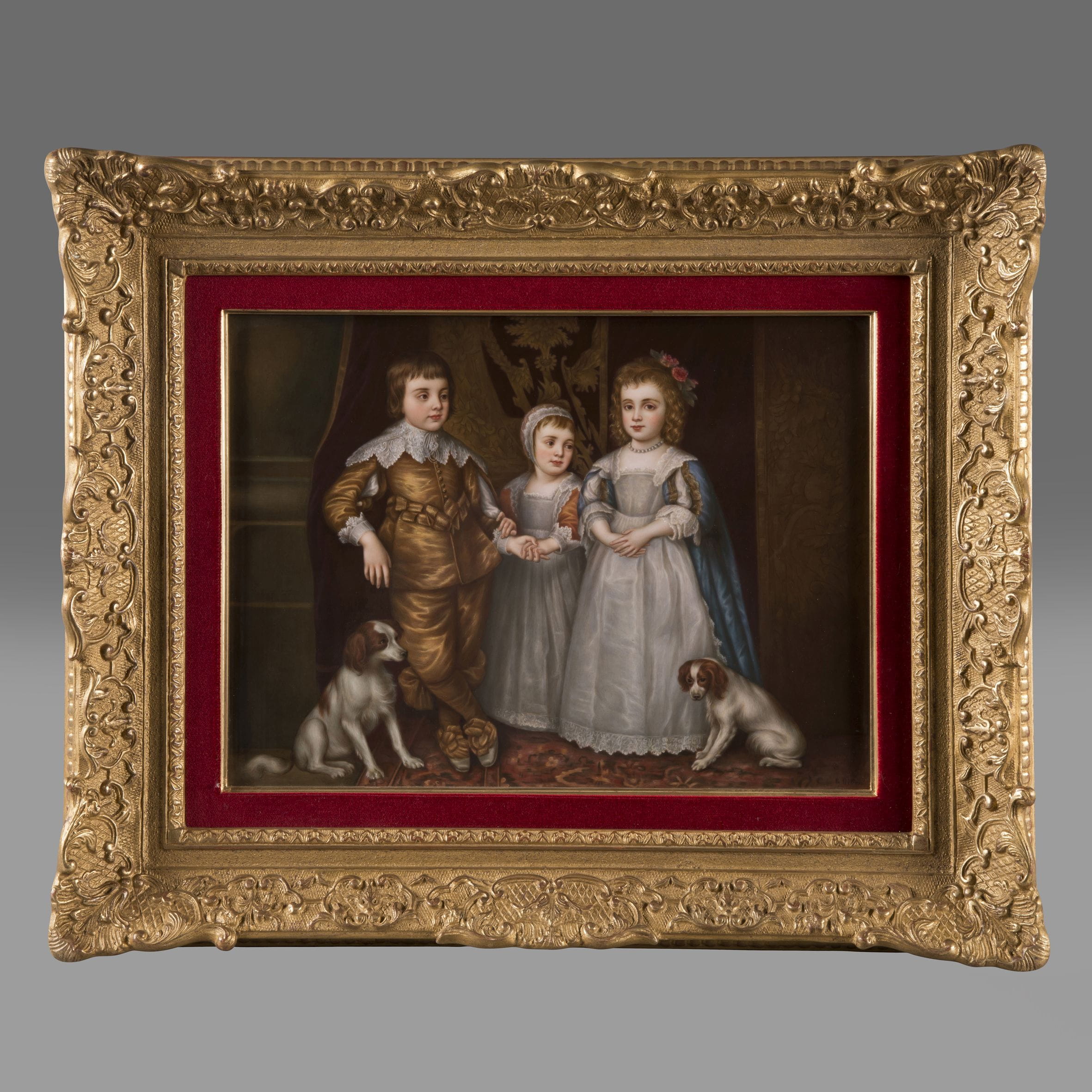 KPM Berlin porcelain plaque depicting the three eldest children of Charles I—Charles II, James II, and Mary—after Sir Anthony van Dyck, set in a giltwood frame with red velvet slip, circa 1890.