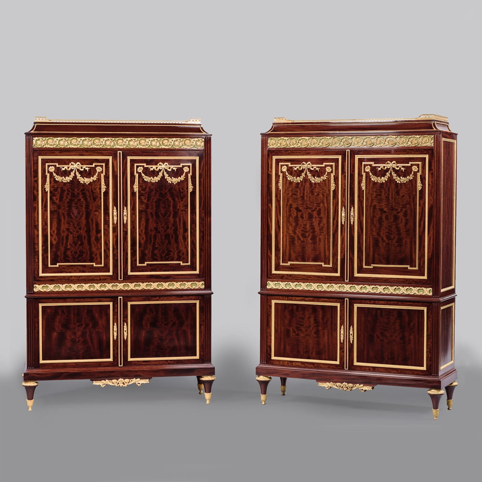 A Fine Pair of Louis XVI Style Gilt Bronze Mounted Mahogany Cabinets