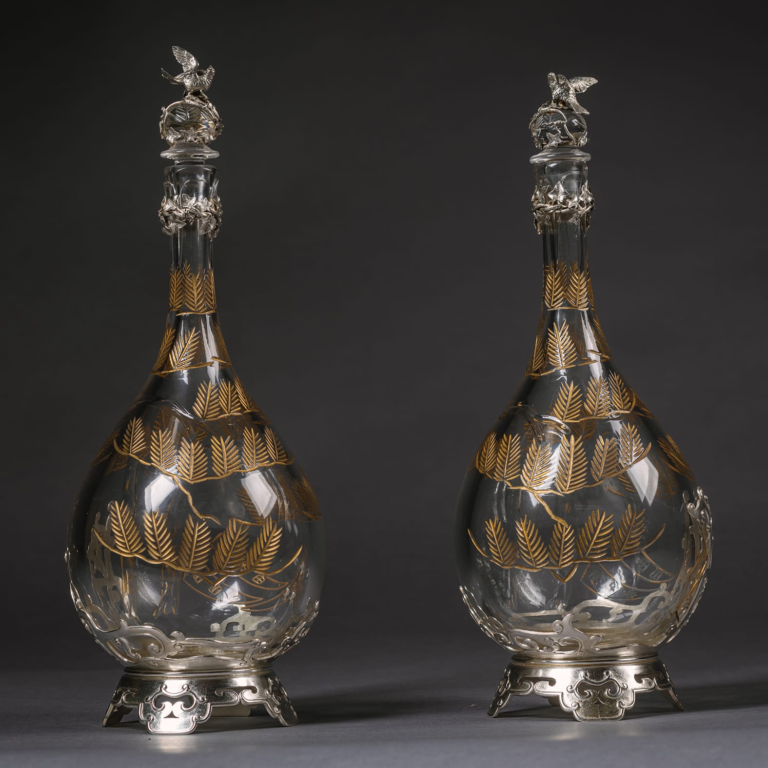 A Pair of ‘Japonaise’ Style Silver Plated and Engraved Glass Decanters