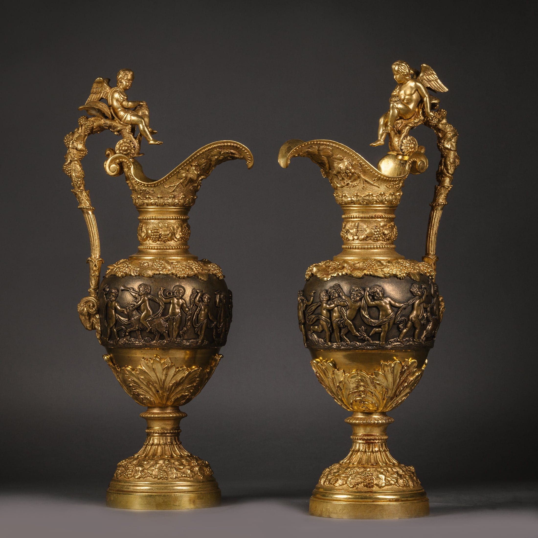 A Pair of Gilt and Patinated Bronze Ewers in the Manner of Clodion