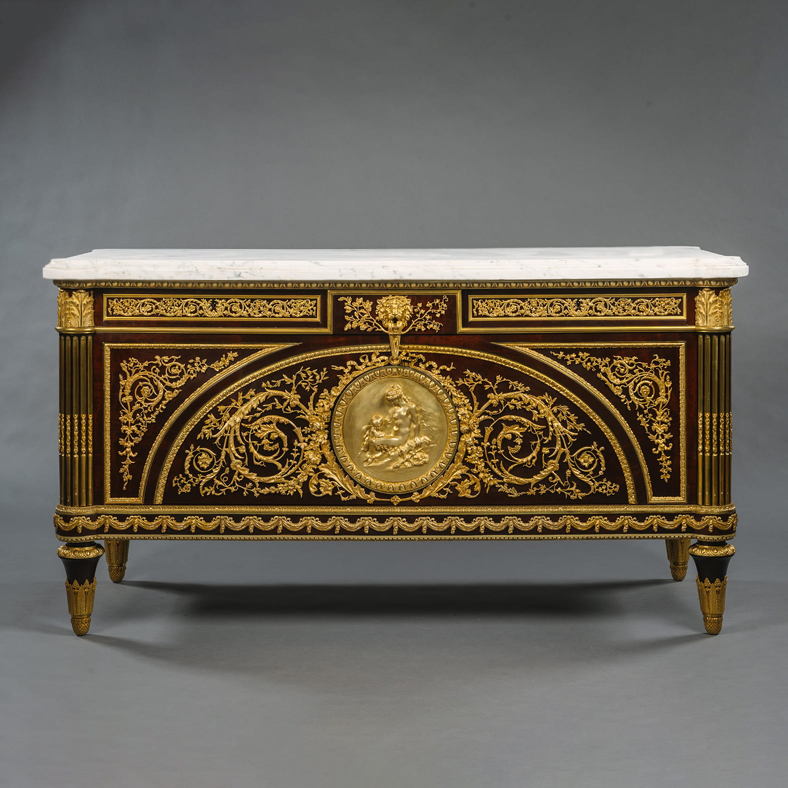 A Louis XVI Style Gilt-Bronze Mounted Mahogany Commode
