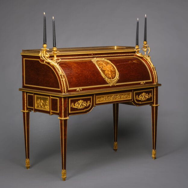 Louis XVI style gilt-bronze mounted mahogany cylinder bureau by François Linke, Paris circa 1890, featuring floral marquetry, gilt candelabra, and green leather writing surface.