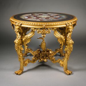 An elaborately carved giltwood table with a pietre dure marble top depicting scenes of Rome's famous landmarks