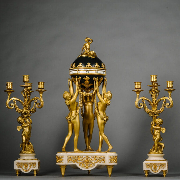 A Louis XVI Style Gilt and Patinated Bronze and Marble Clock Garniture ...