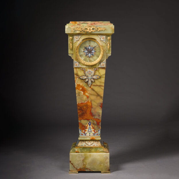 Antique Napoleon III pedestal clock in gilt bronze, onyx, and champlevé enamel, showing full frontal view with dial and pedestal base, France circa 1870.