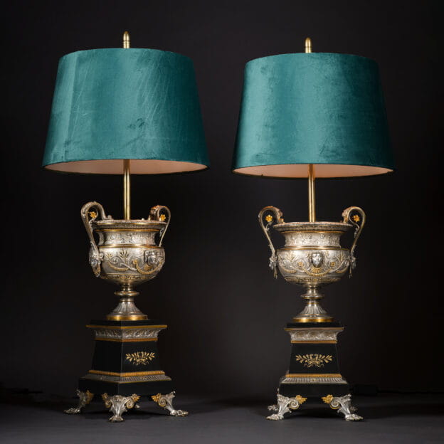 Pair of Napoleon III silvered and gilt-bronze urns on black marble bases, mounted as lamps with green velvet shades, France circa 1860