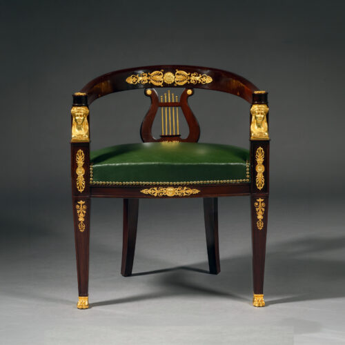 An Empire style desk cahir with rich dark mahogany and green leather seat mounted with Egyptian style gilt-bronze mounts
