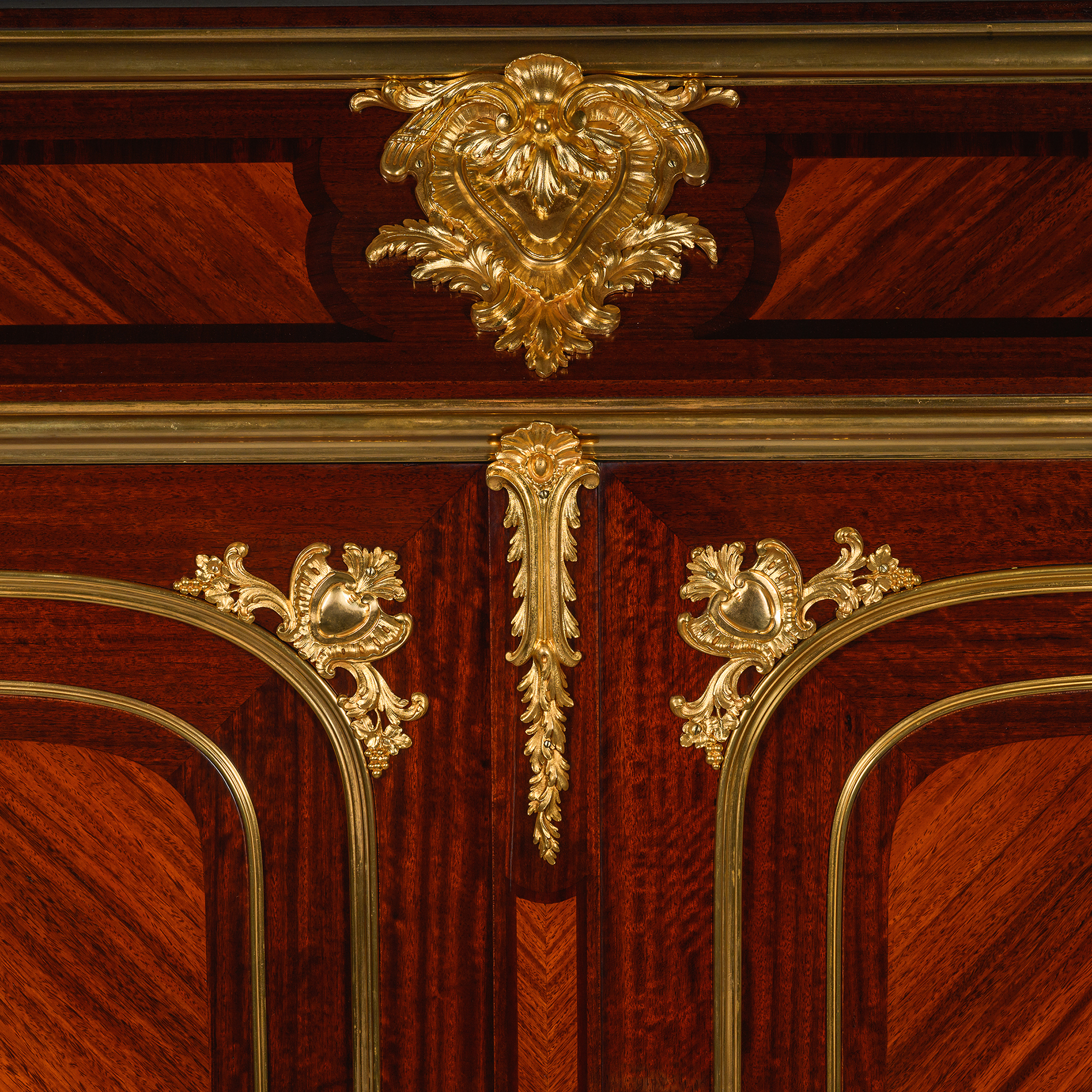 Finely chased ormolu mounts on a Parisian mahogany armoire by Durand.