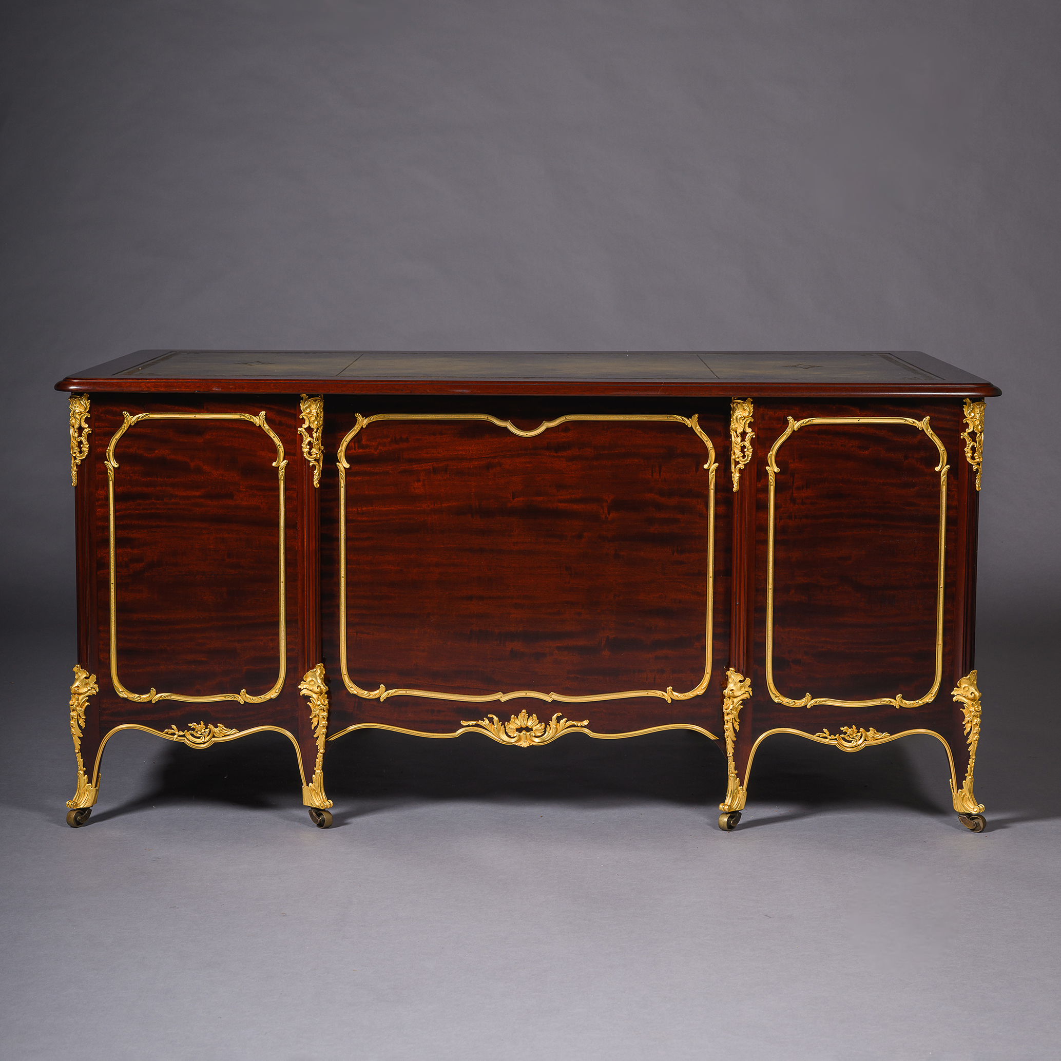 Decorative gilt-bronze encadrements framing desk panels