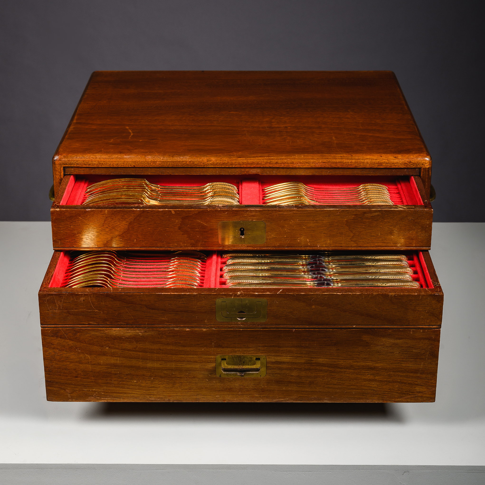 Open canteen drawer revealing fitted interior housing Puiforcat silver-gilt canteen
