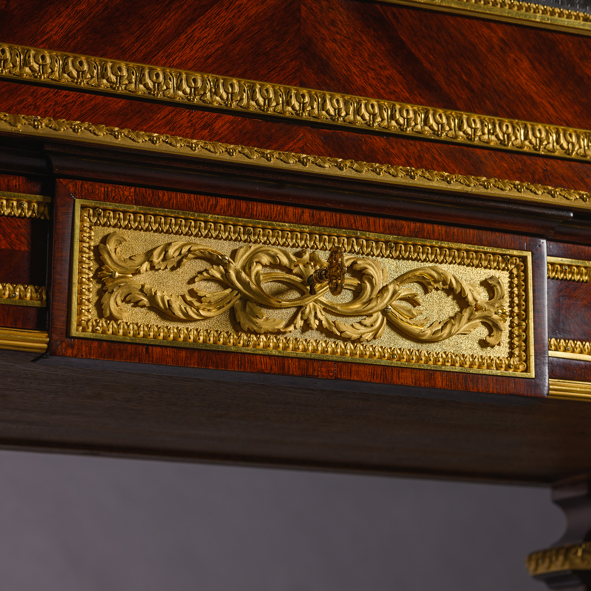 Finely chased gilt-bronze caryatid mounts by Henri Picard on a Louis XVI style mahogany secrétaire cabinet.