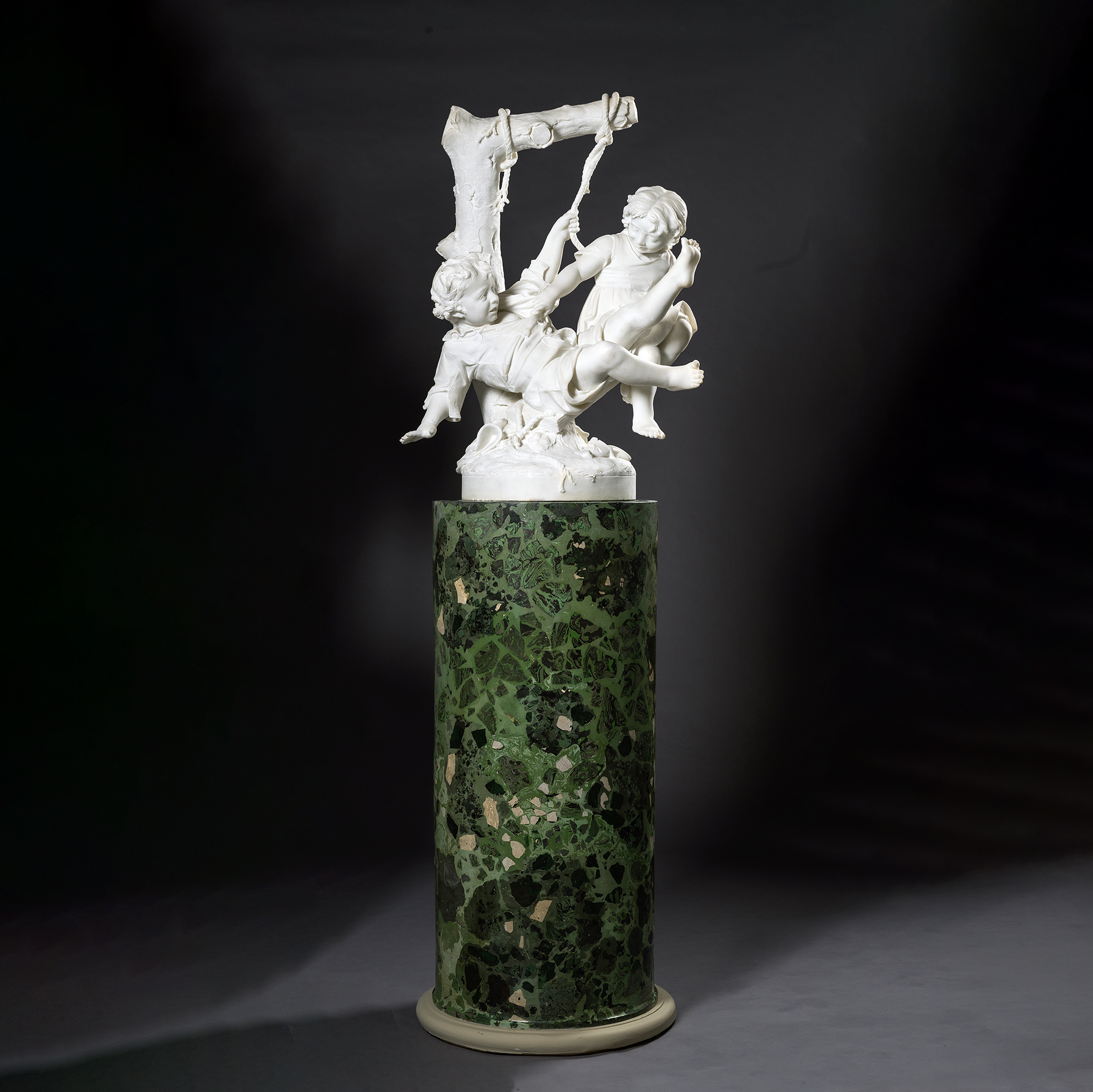 Carrara marble sculpture 'Two Children Falling from a Swing' by Alessandro Lazzerini showing children falling as the swing slips from its support.