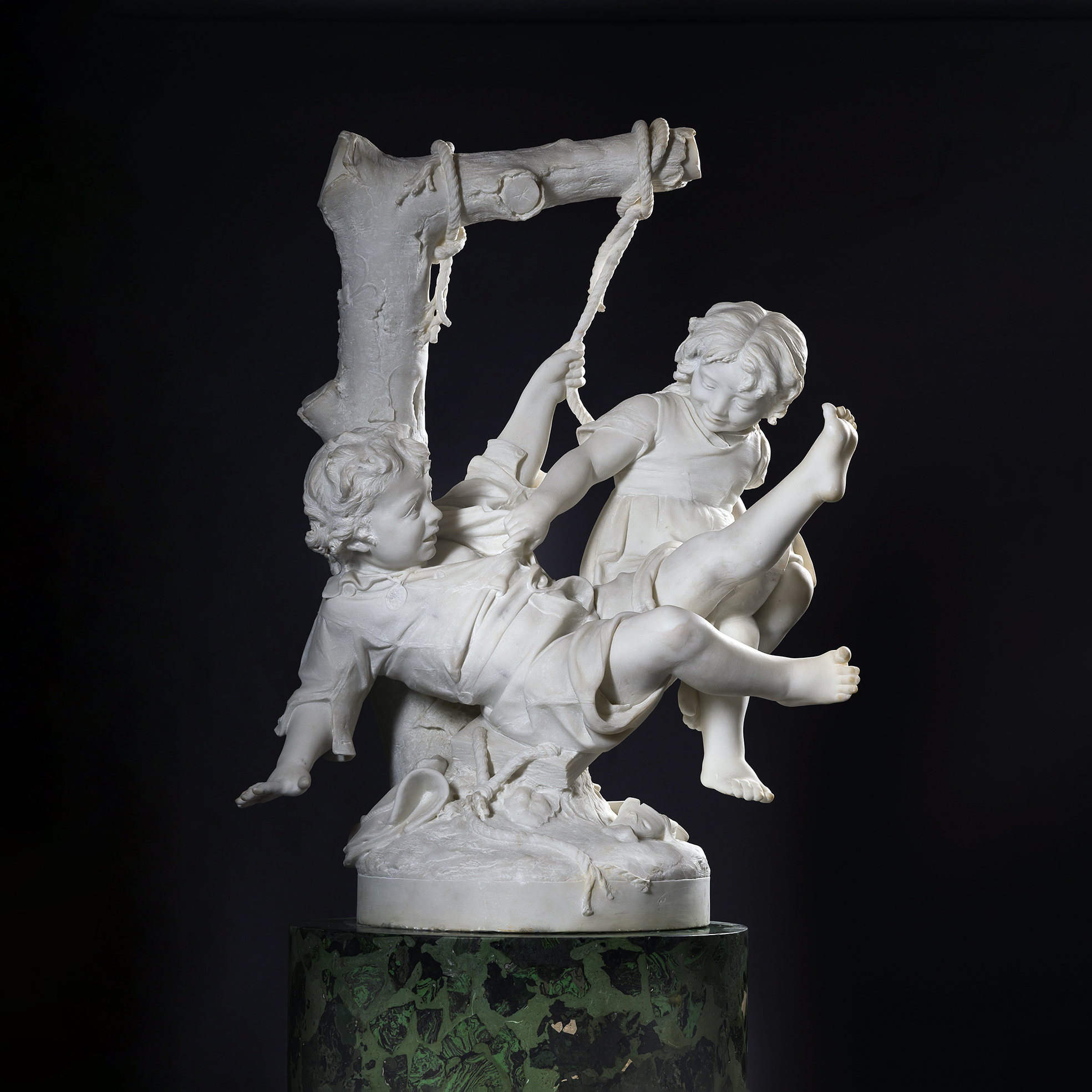 Carrara marble sculpture 'Two Children Falling from a Swing' by Alessandro Lazzerini showing children falling as the swing slips from its support.