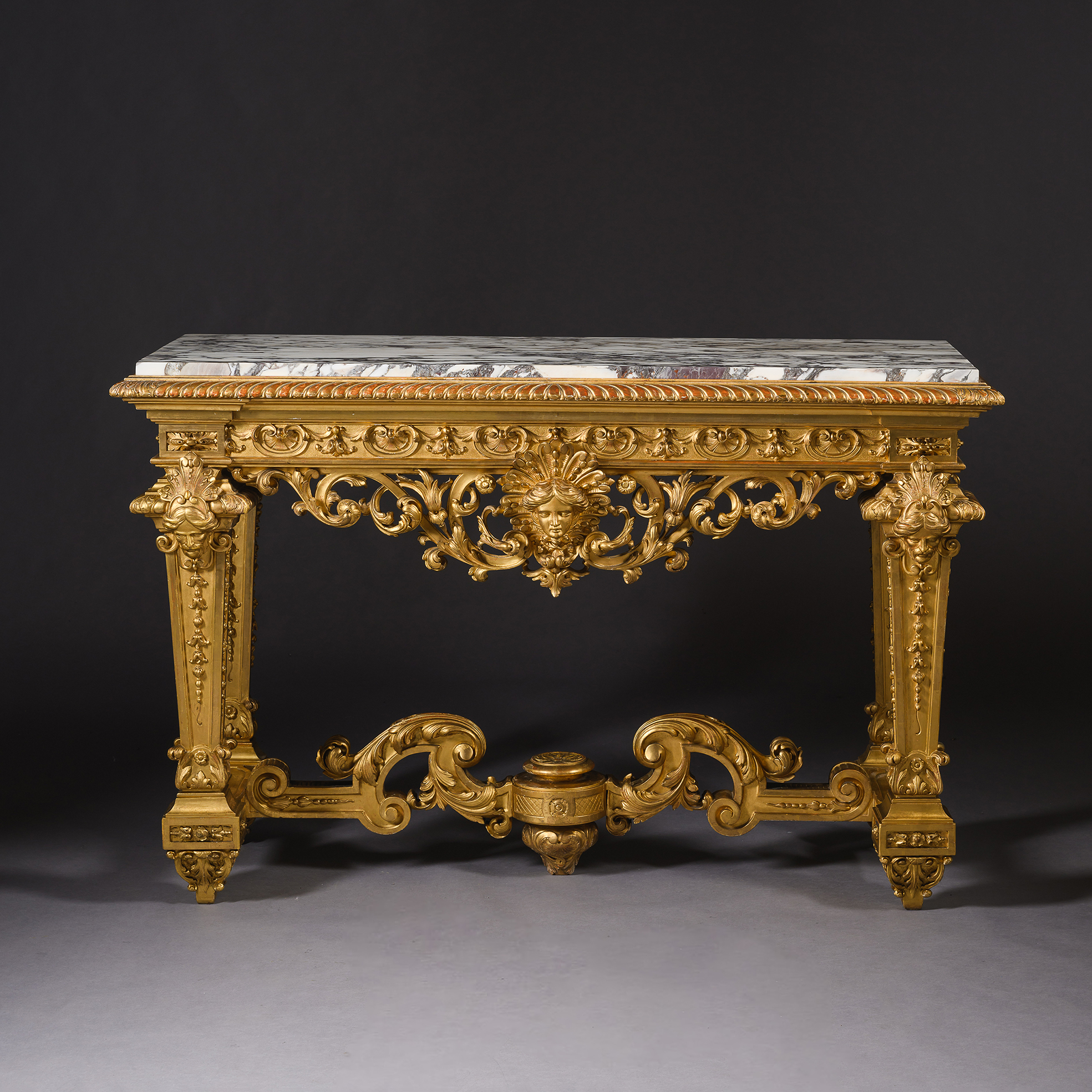 Louis XIV style giltwood console table with brèche violette marble top, carved Apollo mask, lambrequins and giltwood decoration, France, circa 1880.
