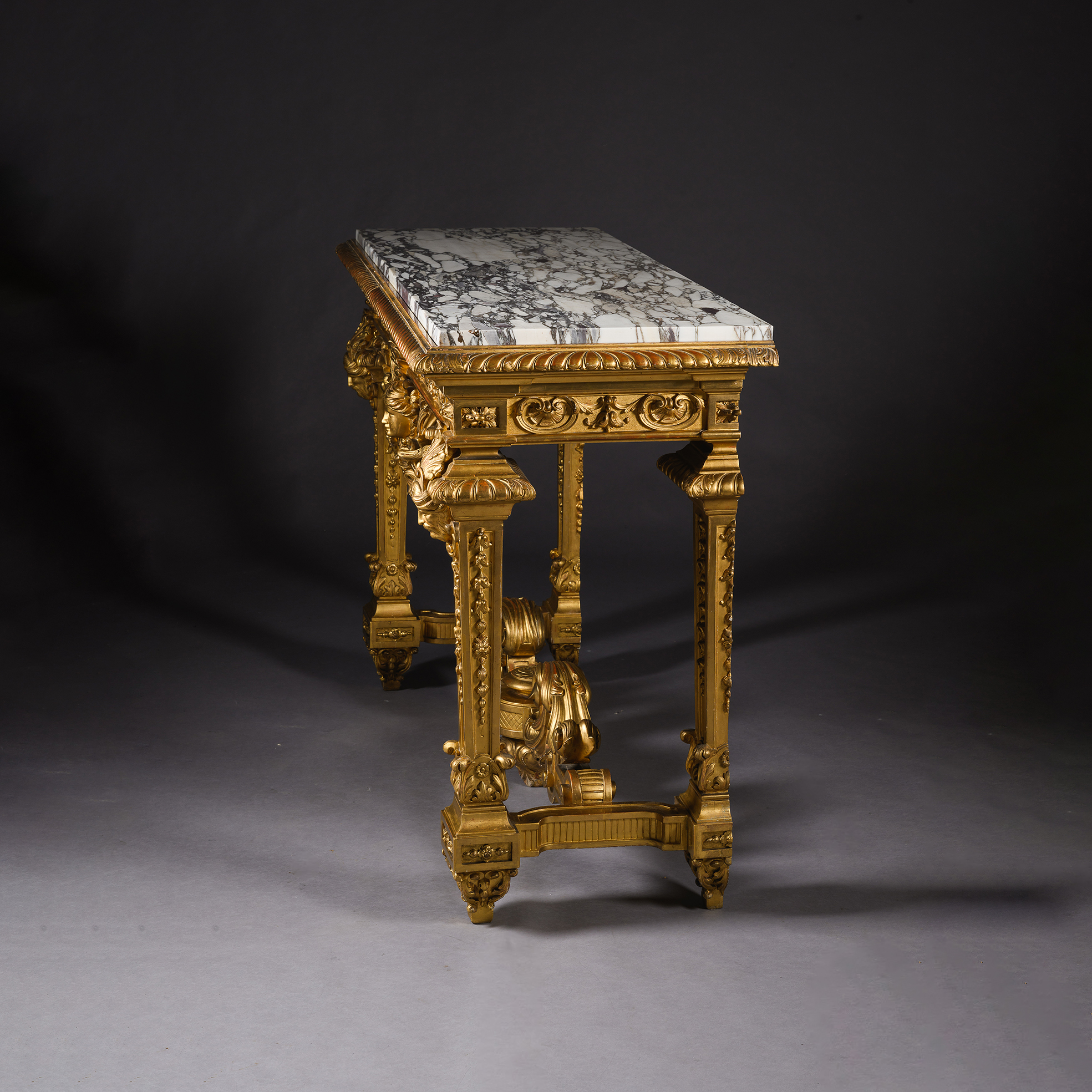 Side profile showing the elegant proportions and carved giltwood decoration.