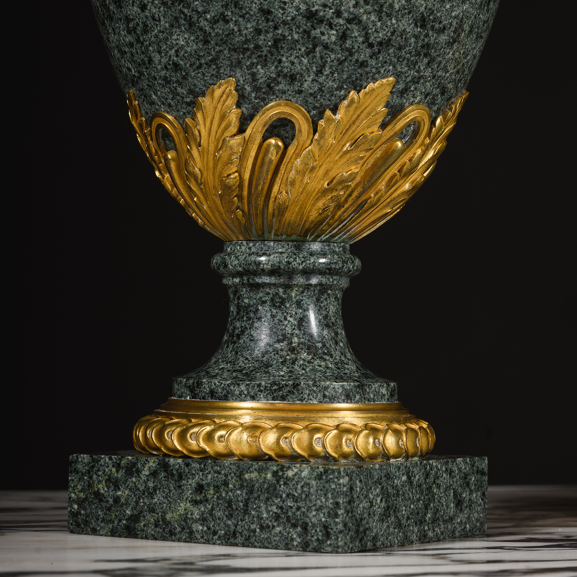 Square foot with gilt-bronze entrelac border supporting a green granite ewer by Henry Dasson.
