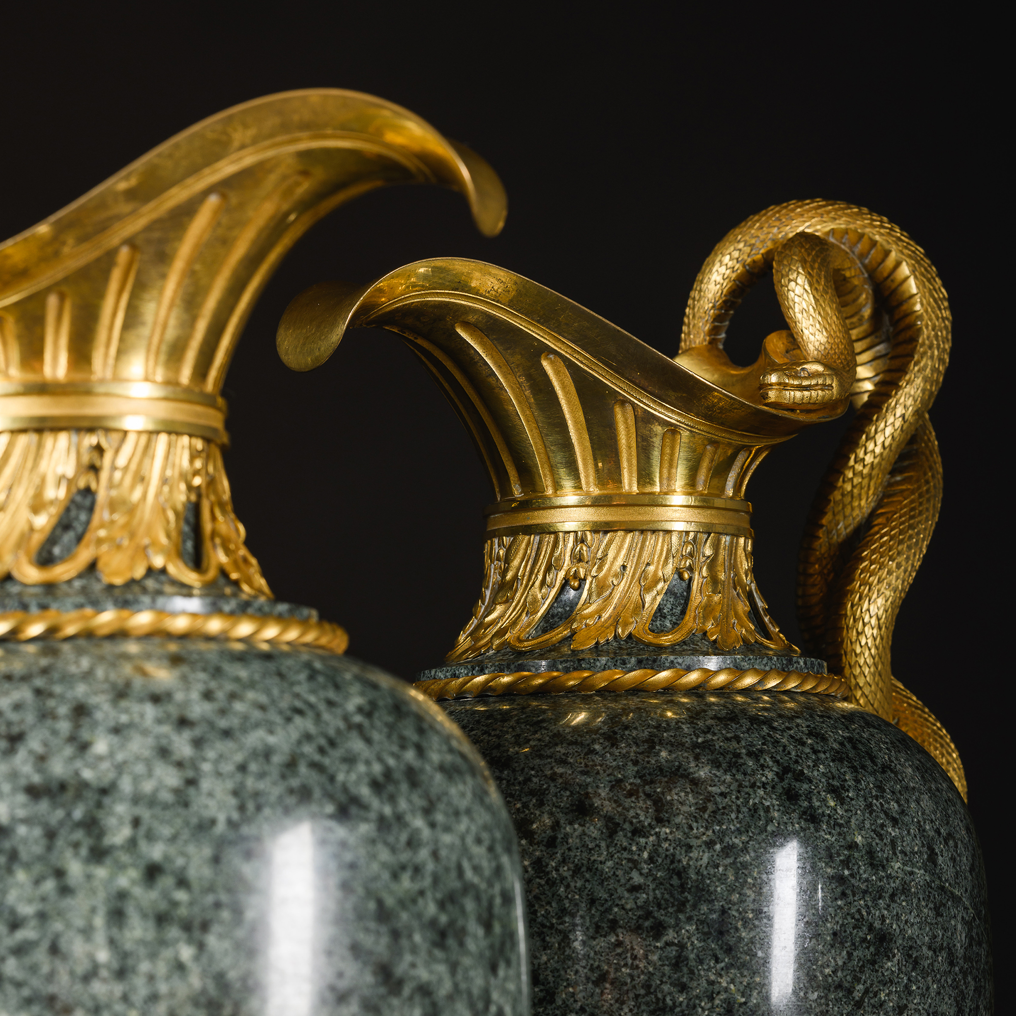 beautifully chased gilt-bronze mounts on a par of granite ewers by Henry Dasson