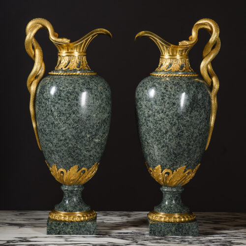 Pair of Louis XVI style gilt-bronze mounted green granite ewers by Henry Dasson, Paris, circa 1880, with entwined serpent handles.