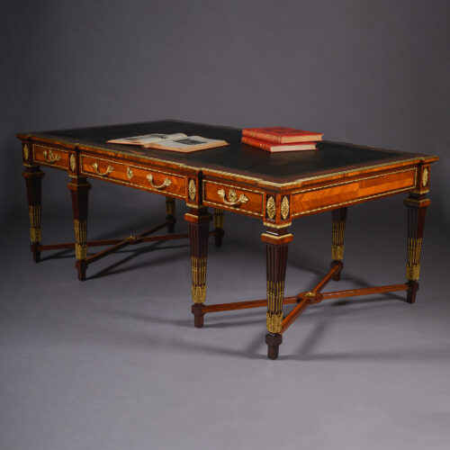 The Luton Hoo Library Table, a monumental Louis XVI style gilt-bronze mounted mahogany and bois satiné centre table designed for Luton Hoo by Mewès & Davis, France, circa 1900.