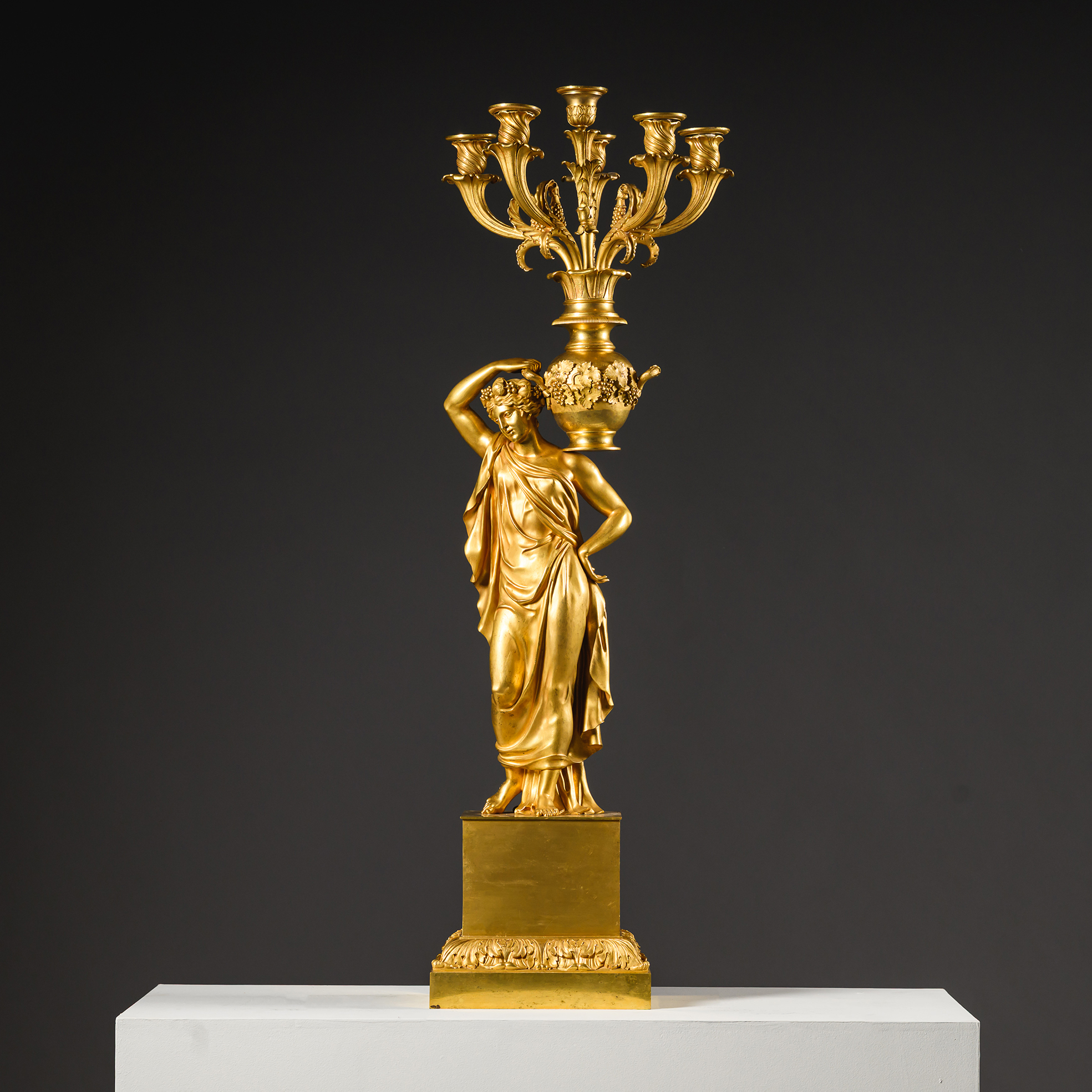 Detail of the classical female figure in a diaphanous robe, supporting the amphora-form upper section of a gilt-bronze candelabrum.