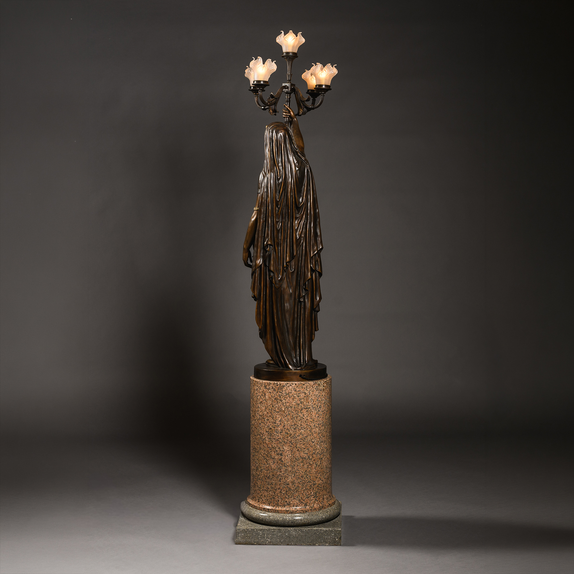 rear view of a large Orientalist patinated-bronze figural torchère entitled ‘Femme Indienne’, sculpted by Émile Guillemin and cast by Ferdinand Barbedienne