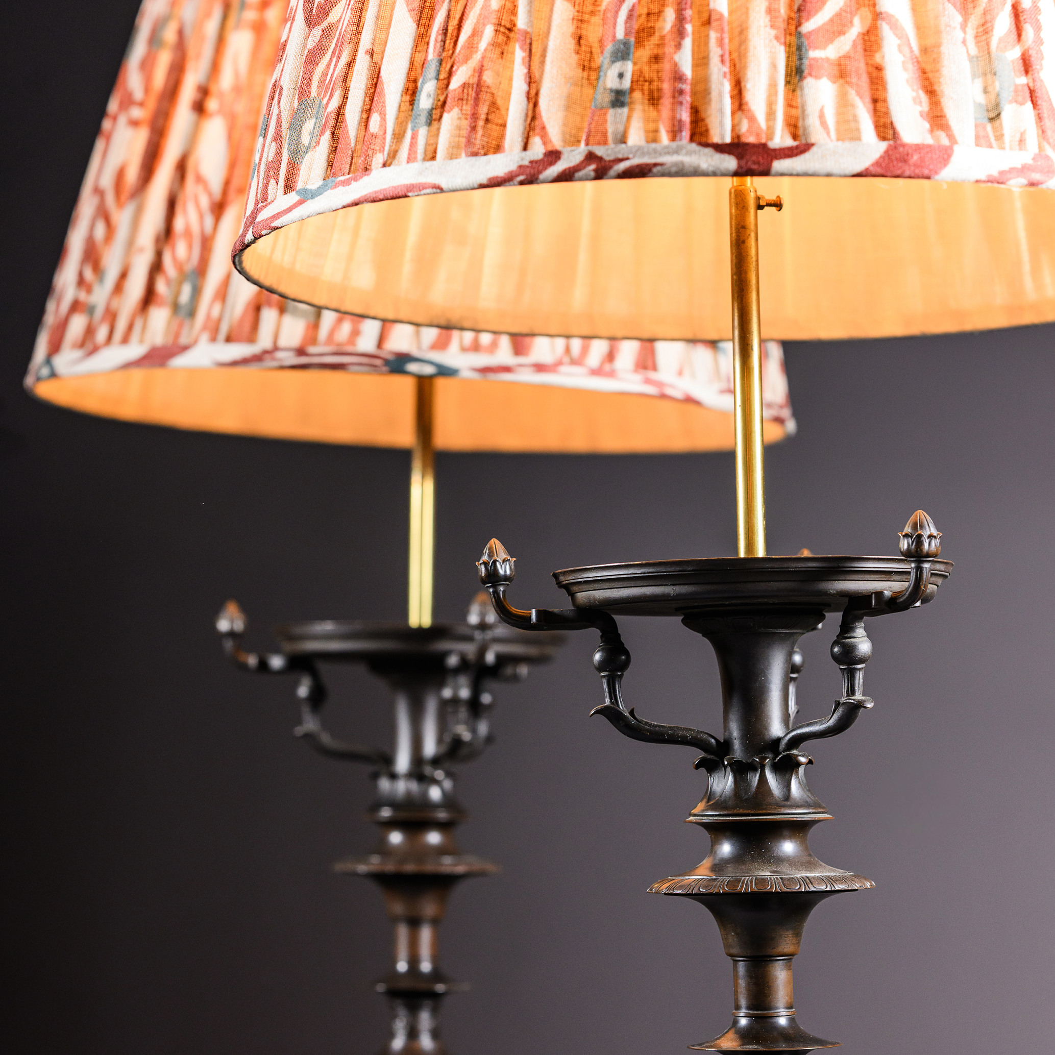 Matching pair of mid-19th-century French patinated bronze torchères inspired by ancient Roman tripod furniture.
